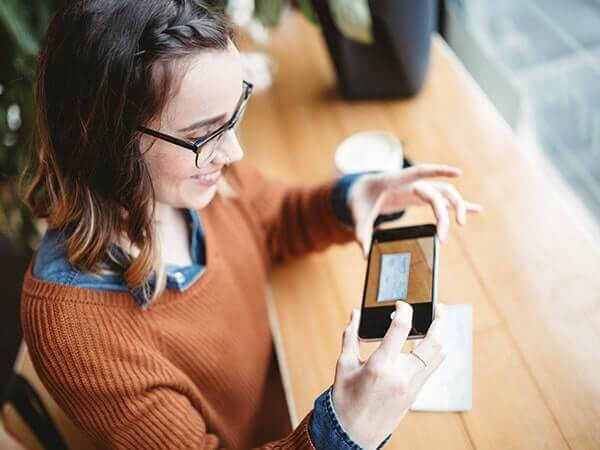 Woman depositing check with mobile app