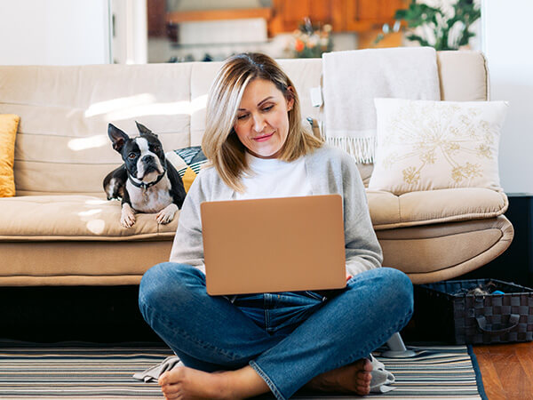 Woman with dog on computer