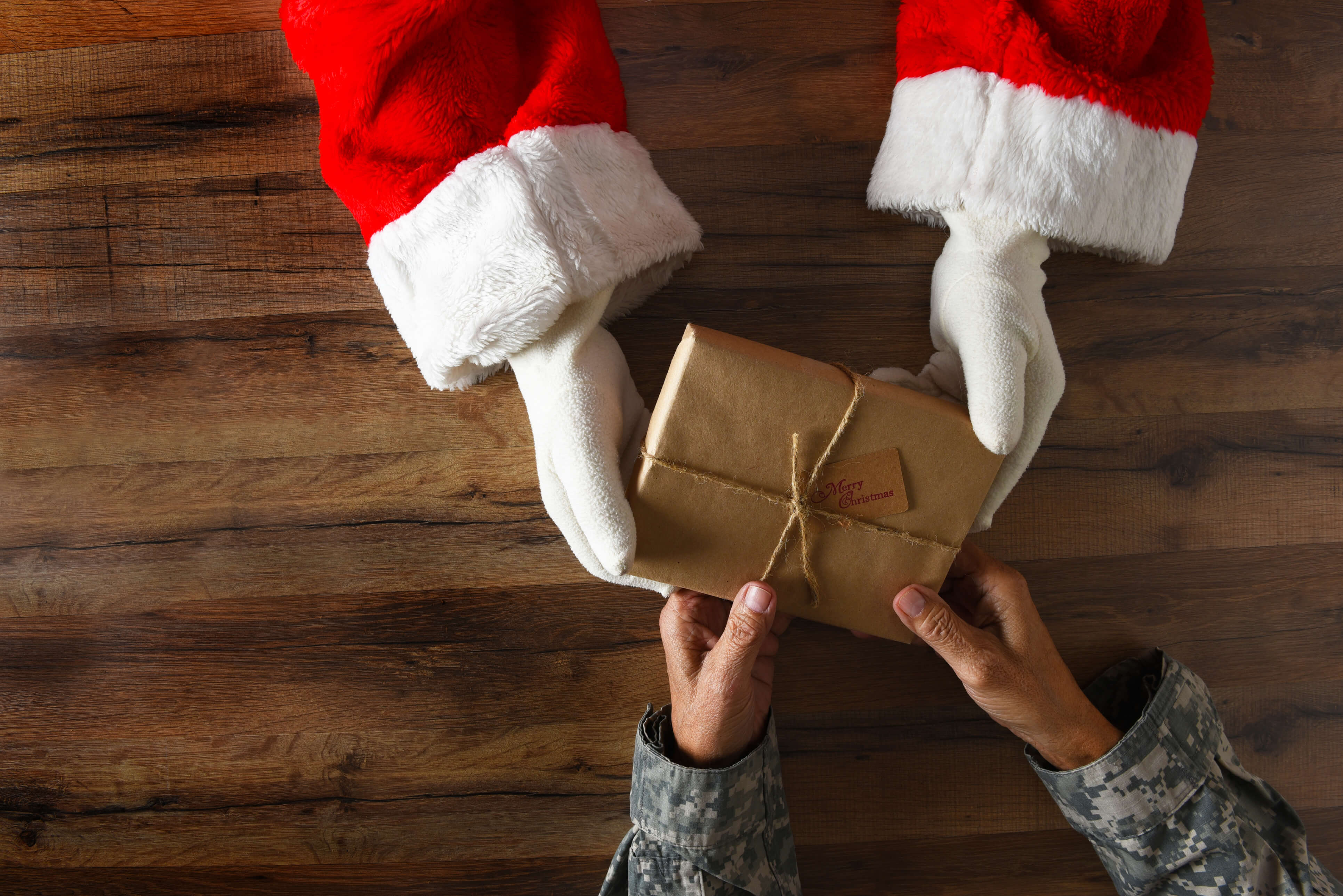 santa handing a veteran a present