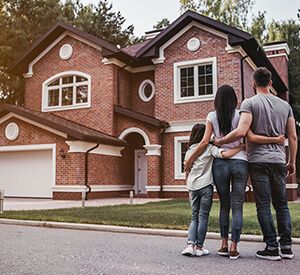 Family standing outside of new home