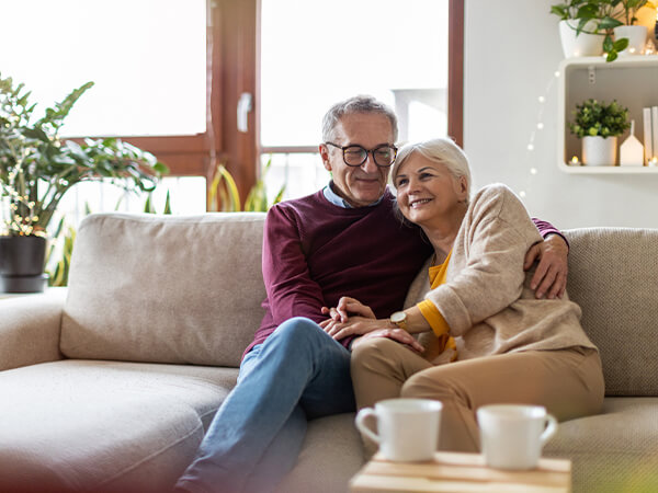 Couple sitting in living room confidently