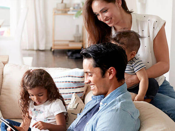 family sitting on couch at home