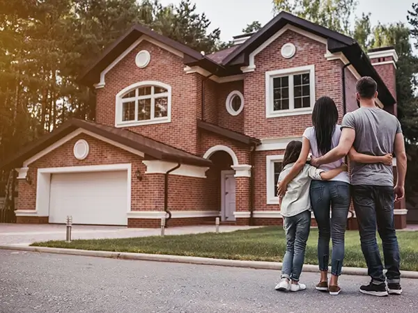 Family standing outside of new home