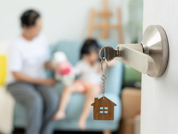 Home key in focus with family in the background