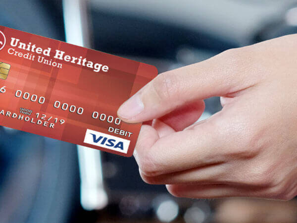 image of two hands holding a debit card